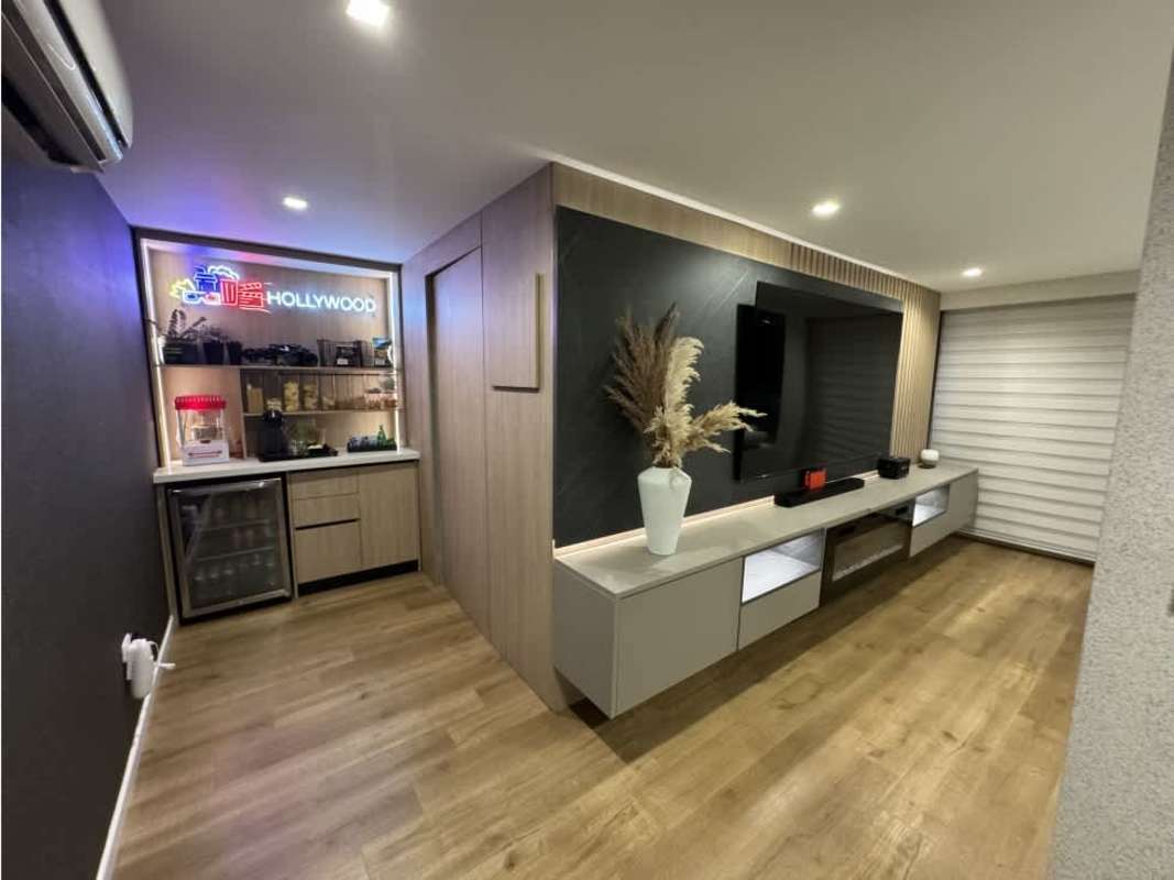 Home fitness gym on covered terrace space with garden and pool view in Panama City