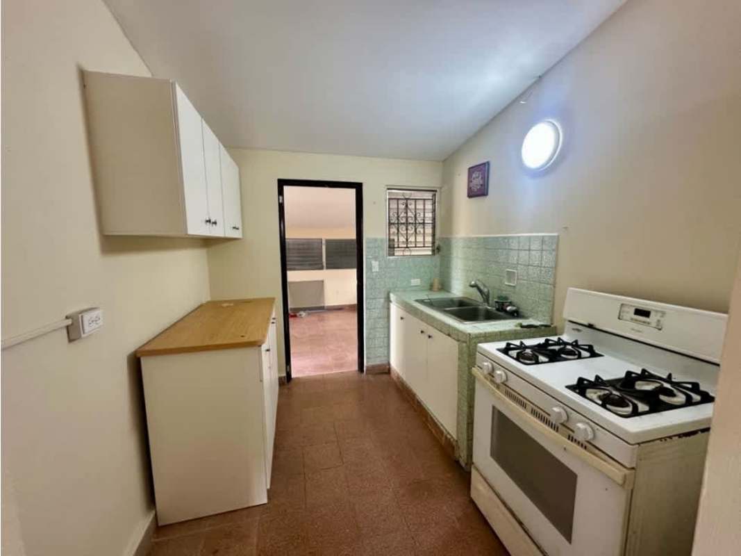 Kitchen area with sink gas stove cabinets windows rental home Chanis Panama City