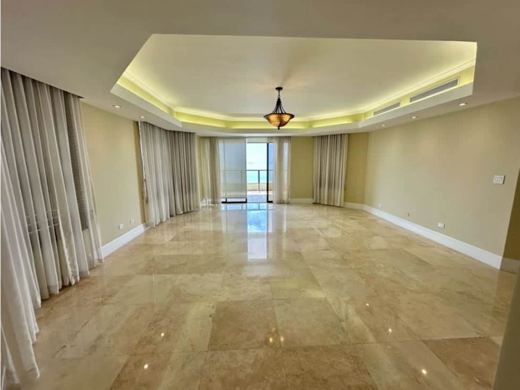 Bright open living and dining room with panoramic windows and marble flooring in PH Regent Punta Paitilla for rent