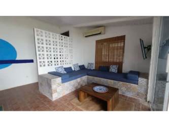 Bright living area with built-in sectional seating, rustic decor in Gorgona Panama Villa