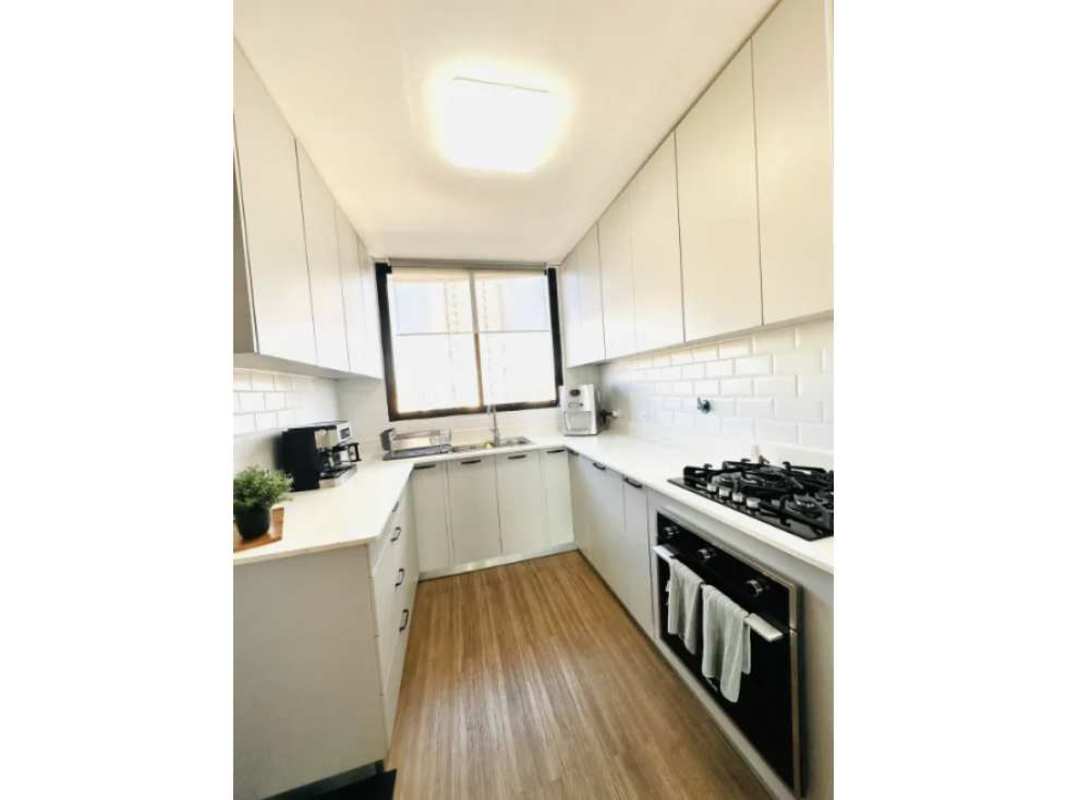 Kitchen with granite counters and wooden cabinets in PH Baleares Coco del Mar Panama