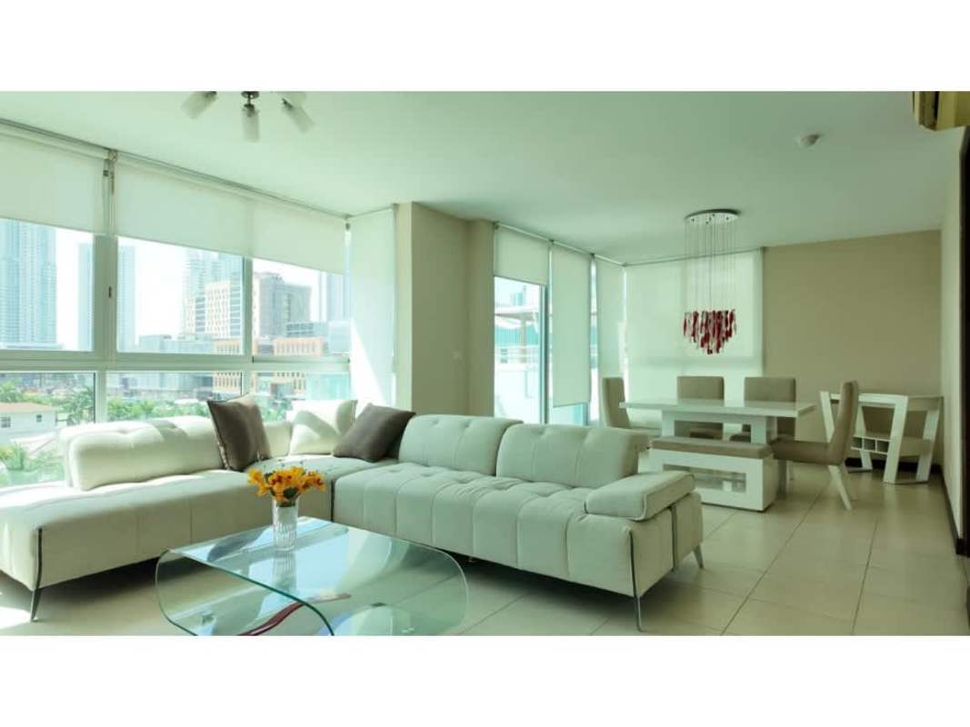 Dining table area with access to balcony overlooking Costa del Este skyline at PH Soho Panama City