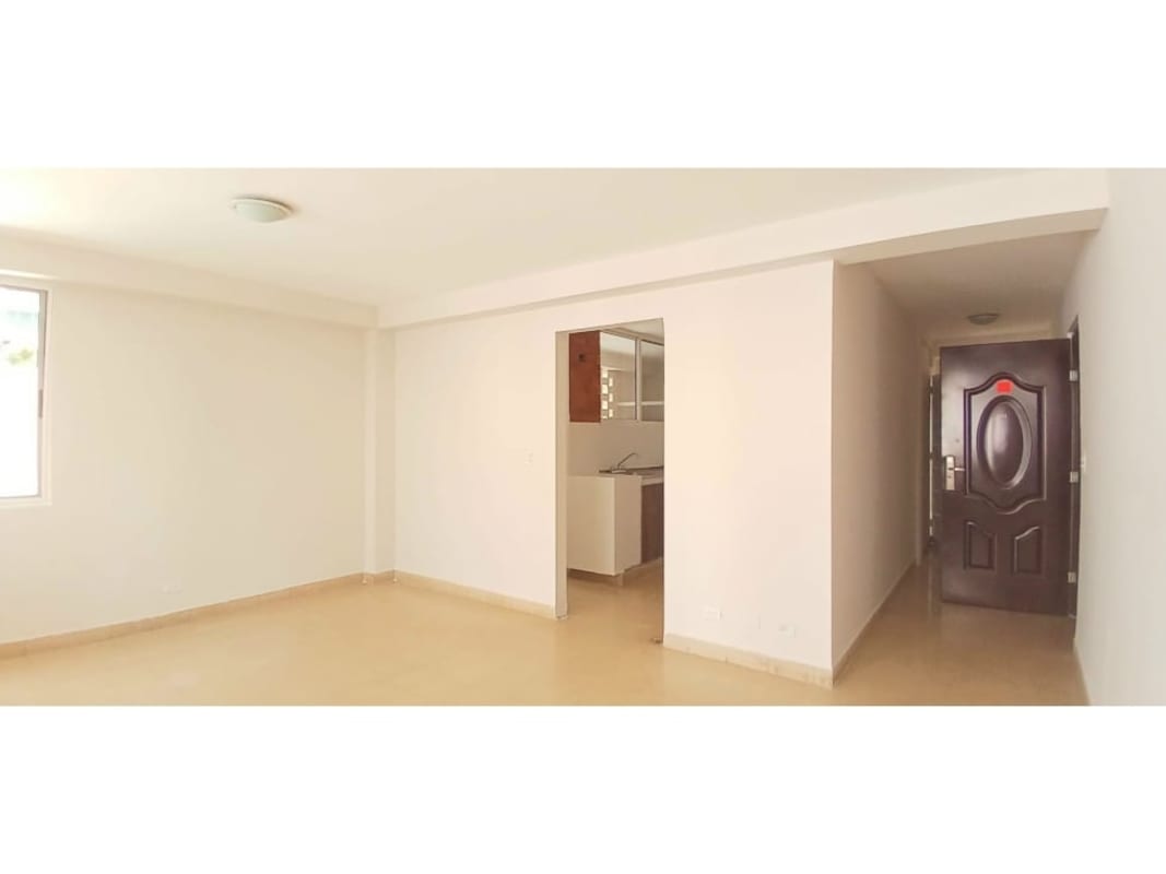 Bright bedroom with neutral tiles large window built-in closet PH Edificio Rattan Vía Argentina Panama