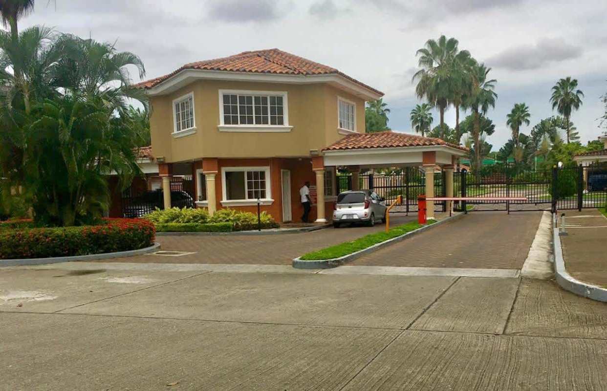 Secure gated entrance with guard booth and palm trees Costa Bay Costa del Este