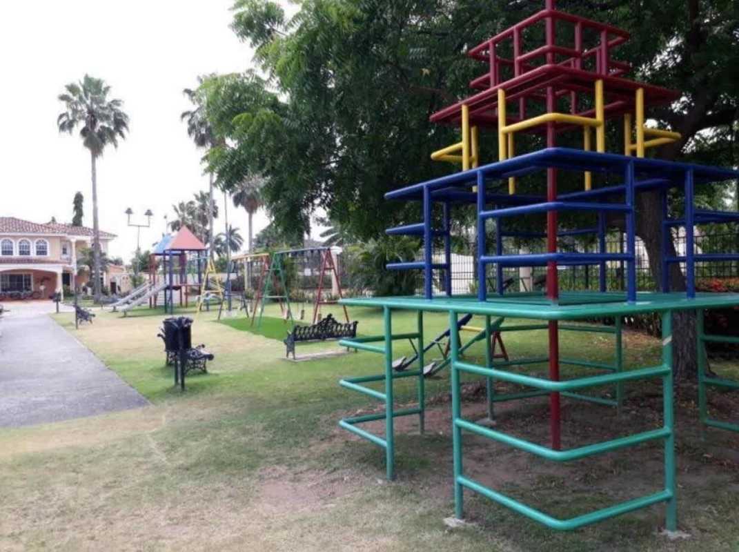 Family-friendly children playground with slides, jungle gym, green lawns in Costa Bay Panama