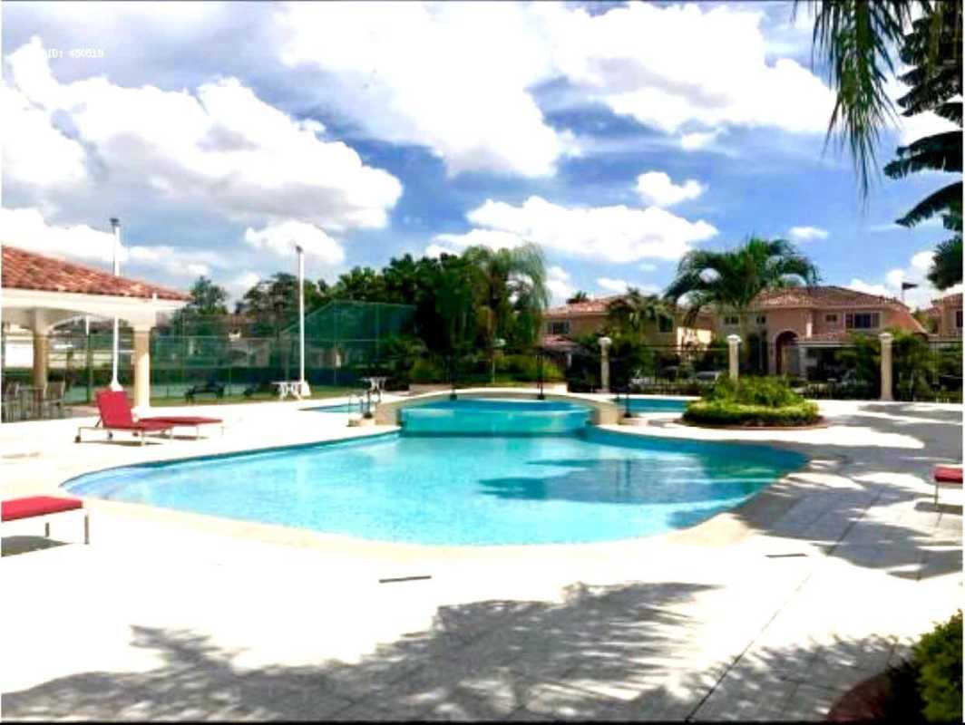 Outdoor swimming pool area with jacuzzi, tennis court, landscaping in Costa Bay Costa del Este Panama