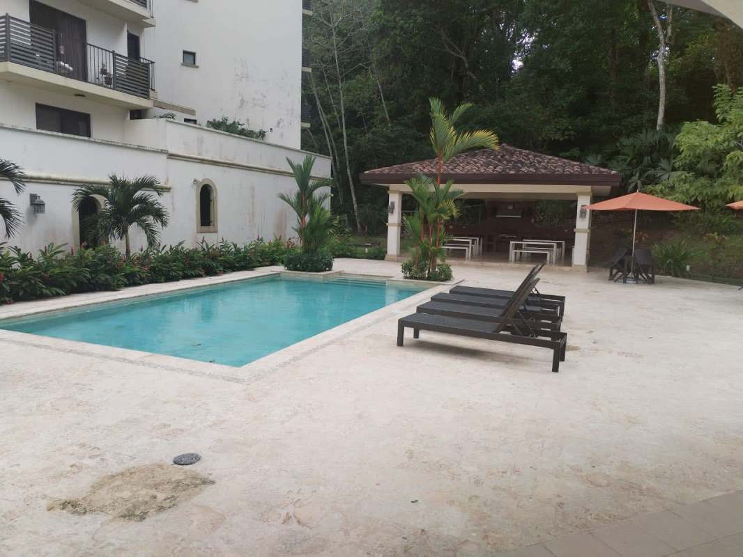 Resort-style pool with lounge chairs and gazebo at PH Embassy Village Clayton