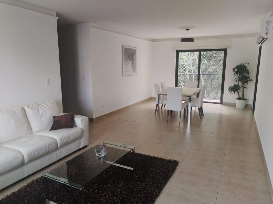 Bright master bedroom with glass door to balcony, queen bed, neutral tones, PH Embassy Village Clayton