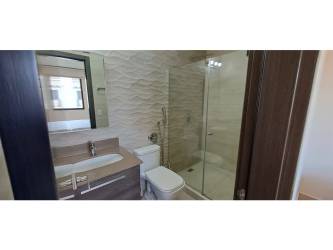 Bathroom with glass-enclosed shower and modern vanity in PH River Valley Panama Pacifico