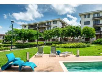 Infinity pool with sun deck overlooking gardens at River Valley Panama Pacifico