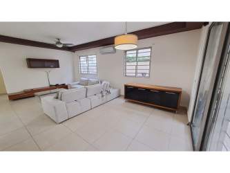 Bright living room with open kitchen and breakfast bar Palmia Woodlands Panama Pacifico