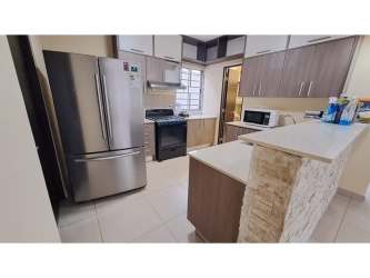 Dining space leading to terrace and garden in house at Palmia Woodlands Panama Pacifico