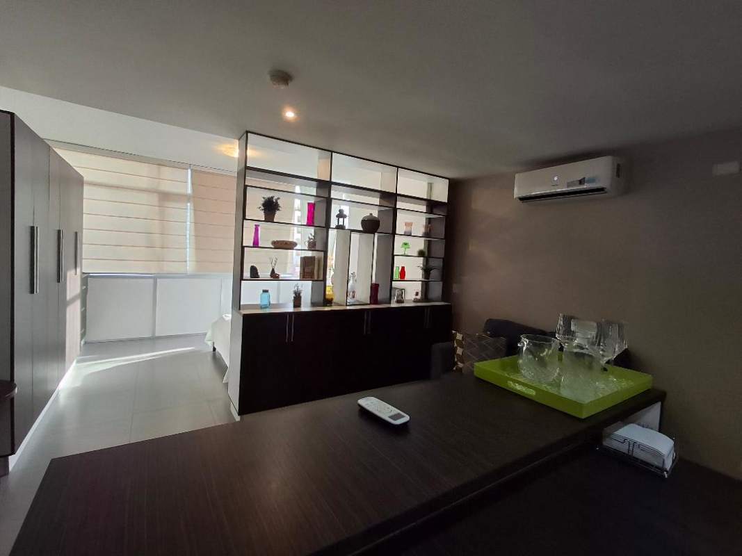 Kitchen with granite counters, breakfast bar, dark cabinetry, stainless appliances in PH Colores de Bella Vista Panama