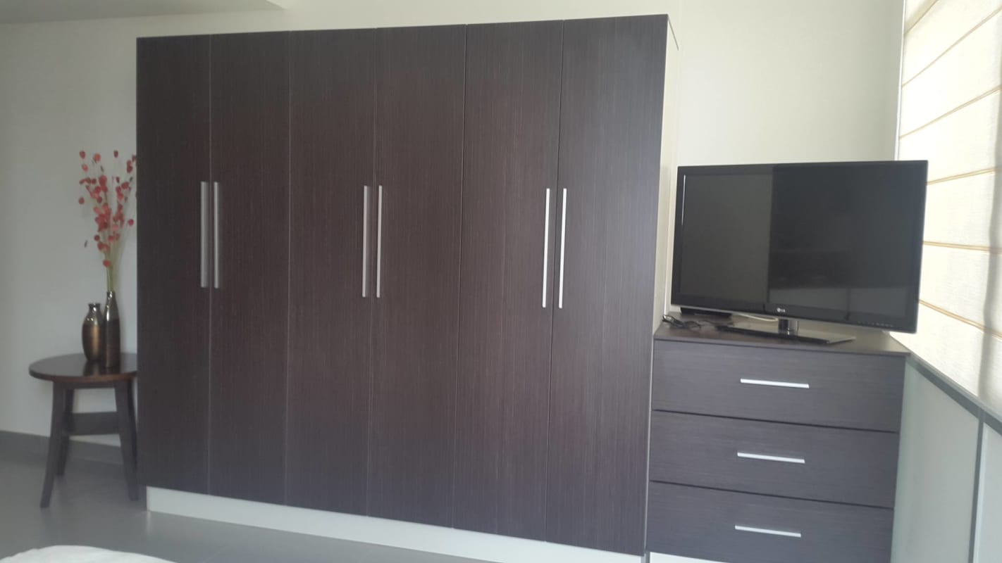 Studio with partition bookshelf, modern furnishings and city view window PH Colores de Bella Vista Panama