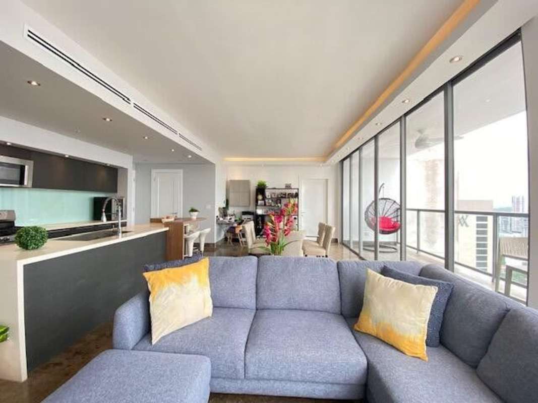 Modern kitchen with island, quartz counters, glass backsplash in Yoo Panama Avenida Balboa