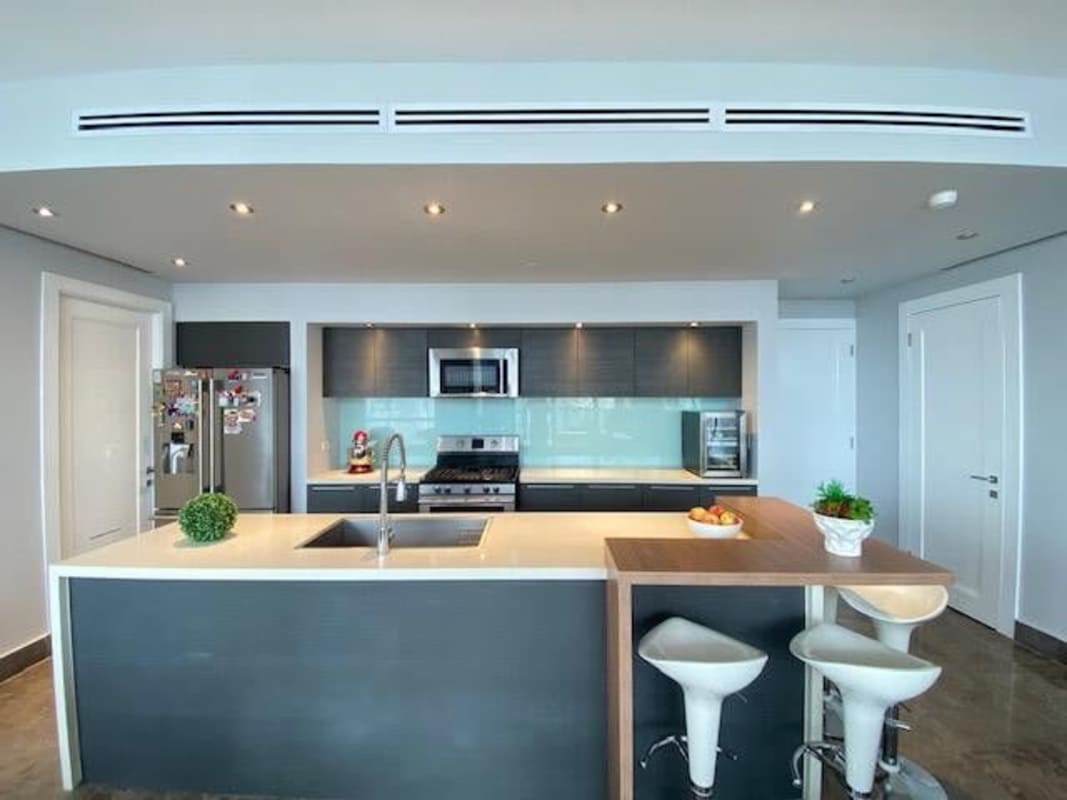 Spacious master bedroom with floor-to-ceiling ocean view windows at Yoo & Arts