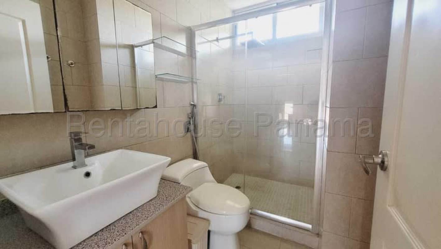 Modern ensuite master bedroom with large window and tile floor in PH Creta Panama