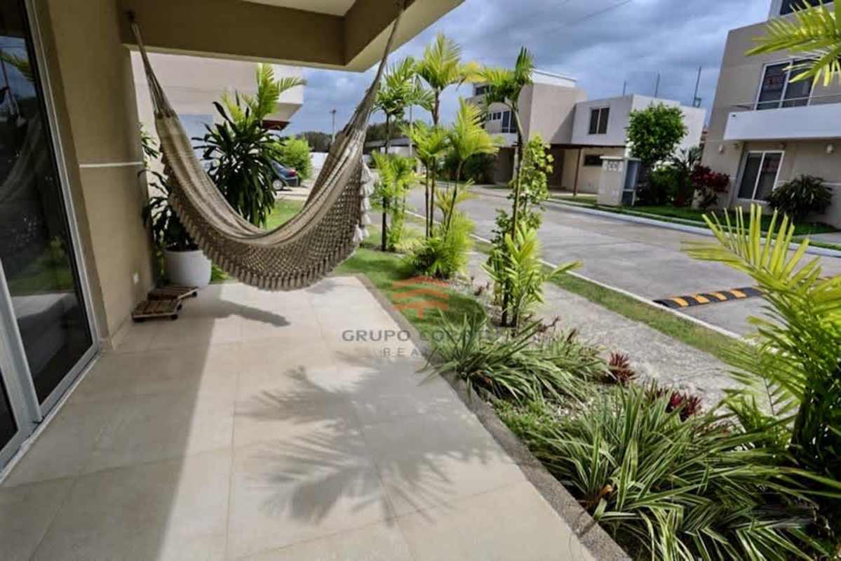 Cozy covered patio with hammock overlooking tropical garden in Costa Sur duplex