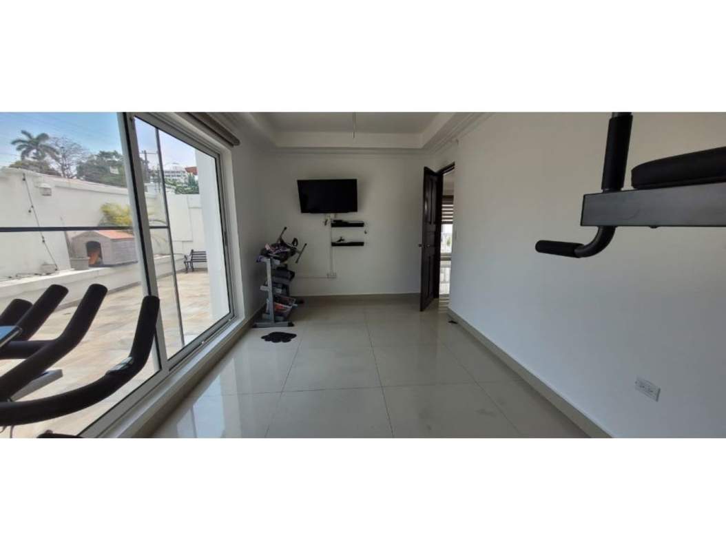 Home gym with large sliding glass window and fitness equipment in Altos del Golf Panama