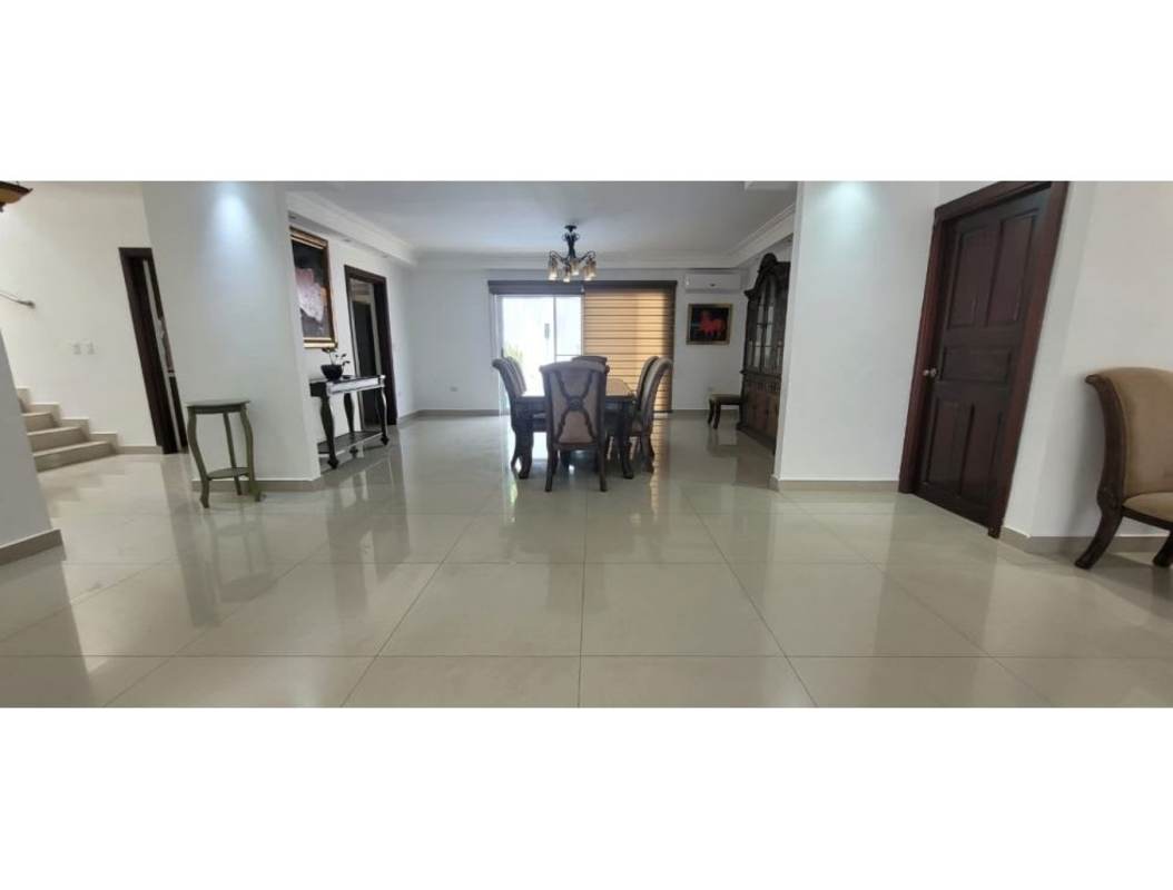 Dining room with glass doors, chandelier, staircase view in upscale house Altos del Golf Panama