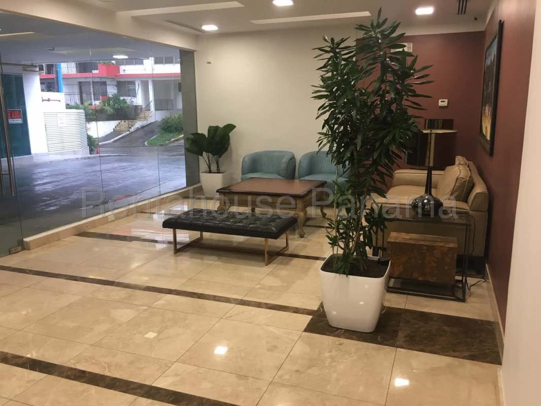 Lobby of PH Trinity featuring marble floors, blue and beige seating and natural light El Cangrejo Panama City