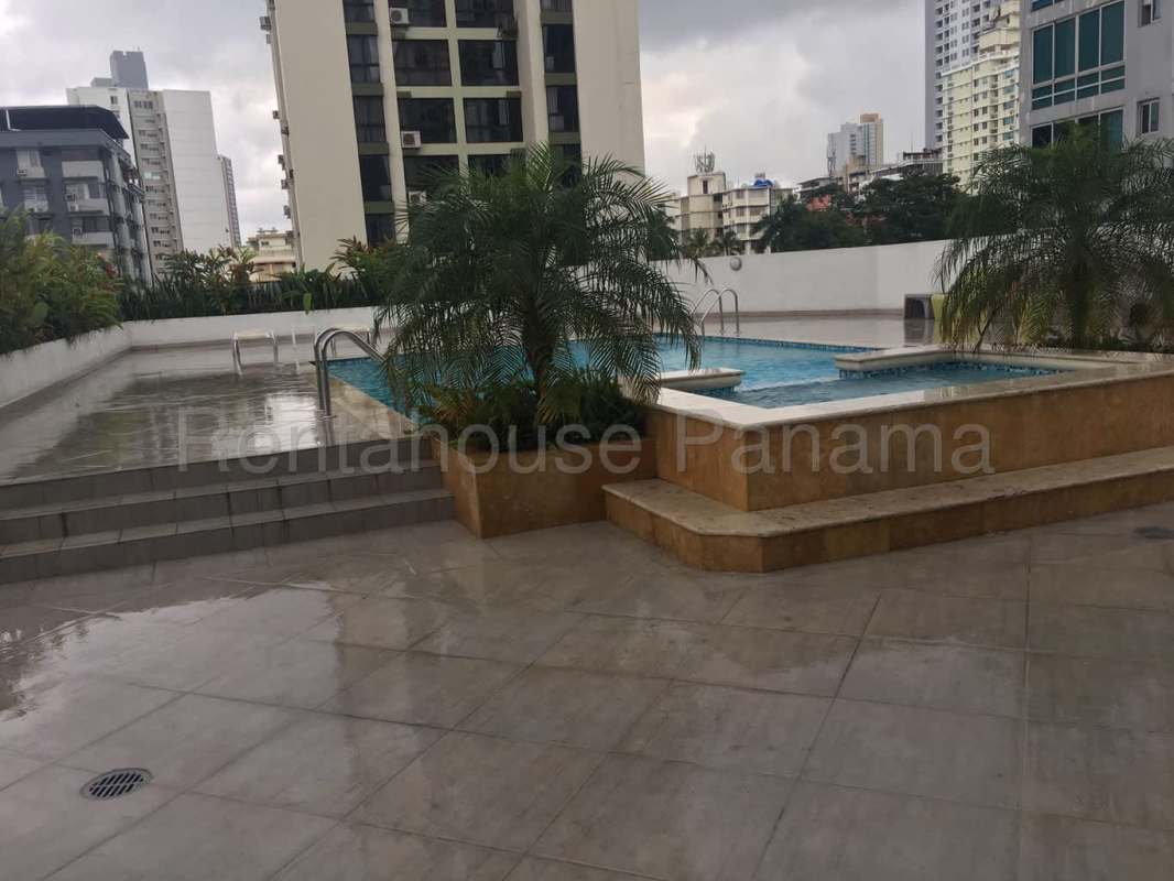 Modern open kitchen with granite countertops and laundry appliances PH Trinity El Cangrejo