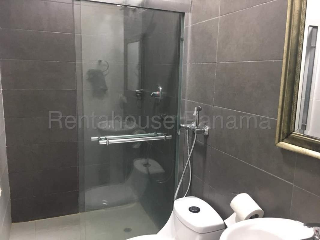 Contemporary bathroom with glass shower and gray tiles PH Trinity El Cangrejo Panama