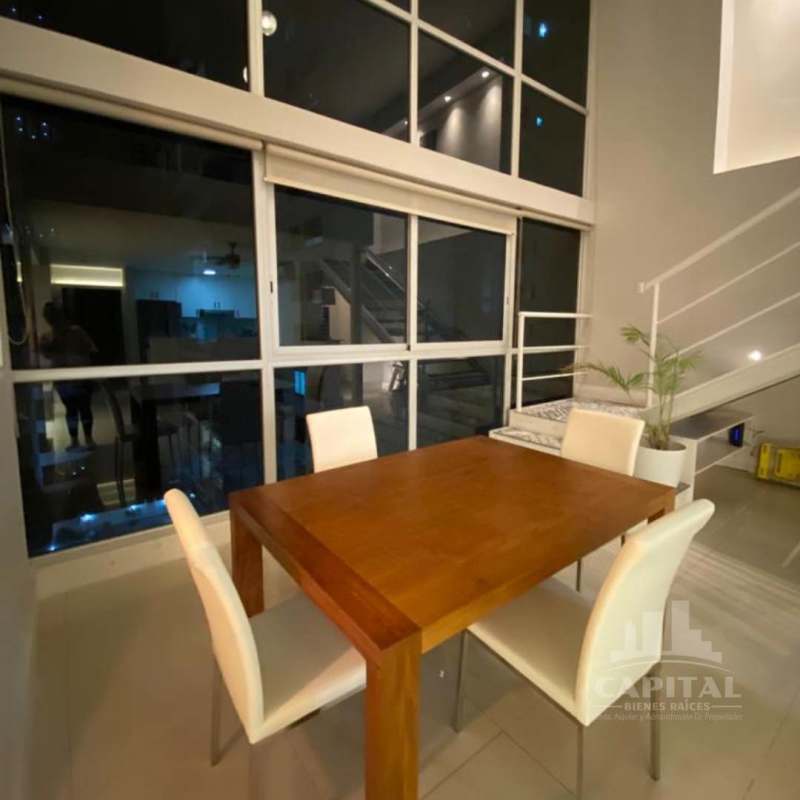 Living area with mezzanine, double-height windows, ceiling fan at PH Vitro Loft Bella Vista panama city