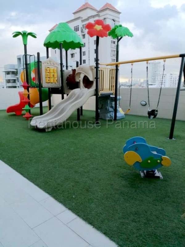Children's playground rooftop with synthetic turf and views PH Rainbow Tower Panama