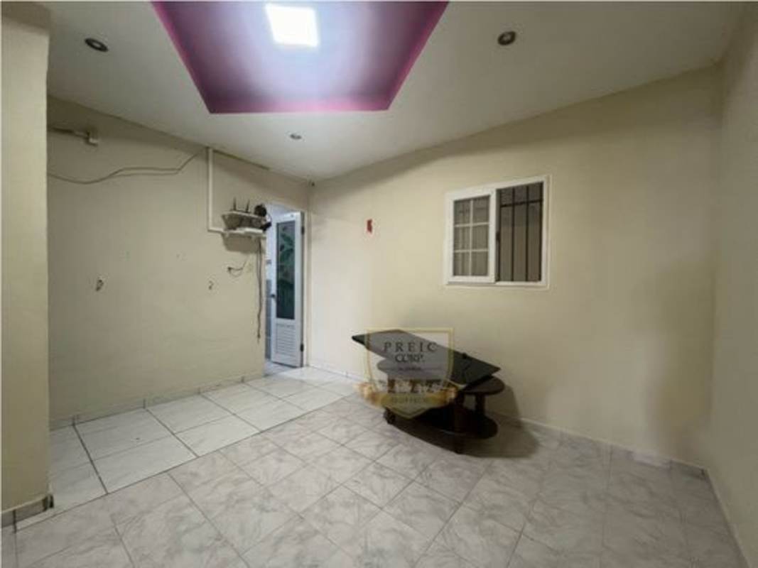Empty tiled bedroom with beige walls, magenta recessed ceiling, Tocumen house