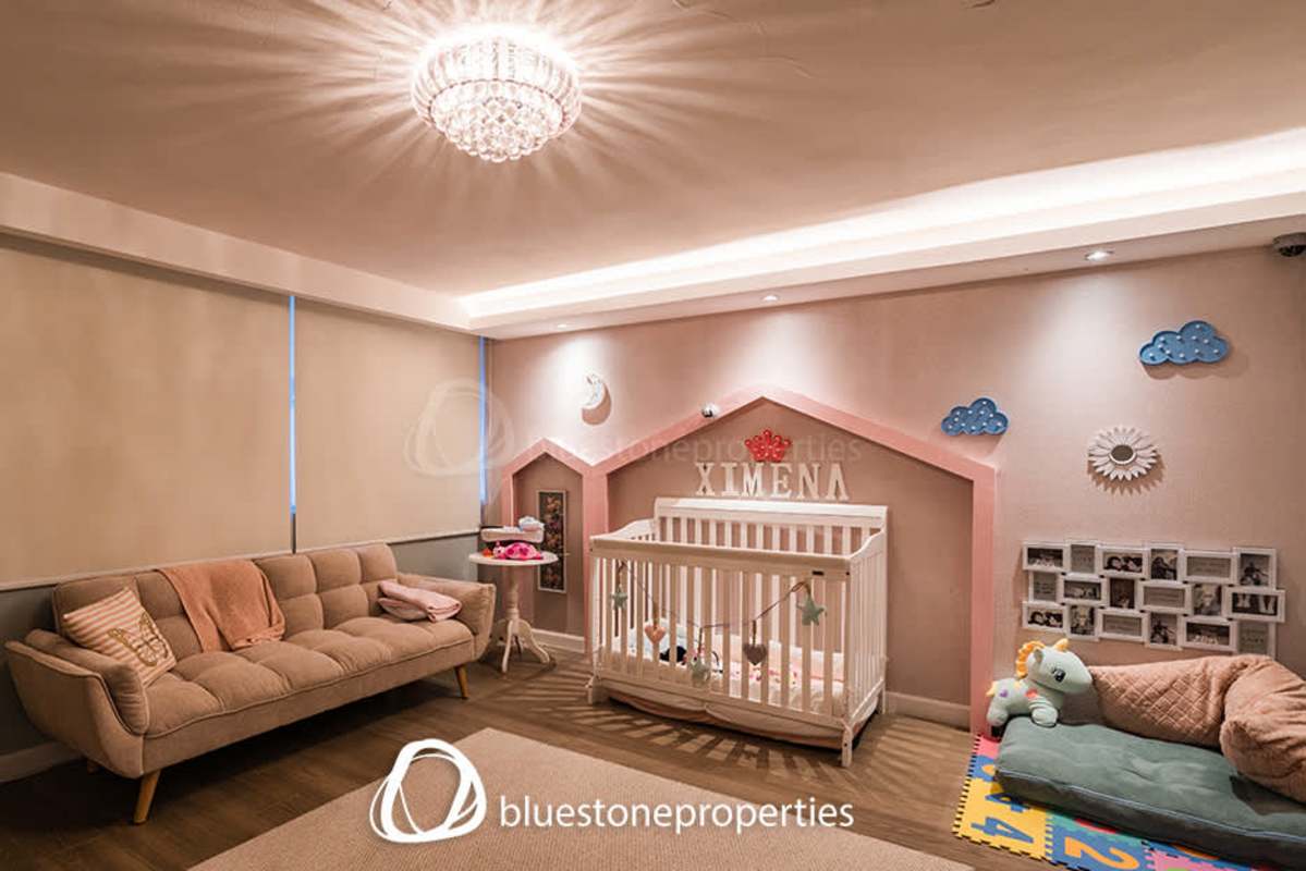 Beautiful nursery with soft play mat, crib, house-shaped wall accent in Punta Paitilla home