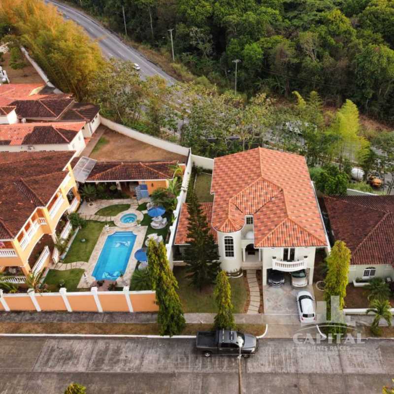Aerial of two-story Mediterranean house with pool, hot tub, patio and driveway Rainforest Village
