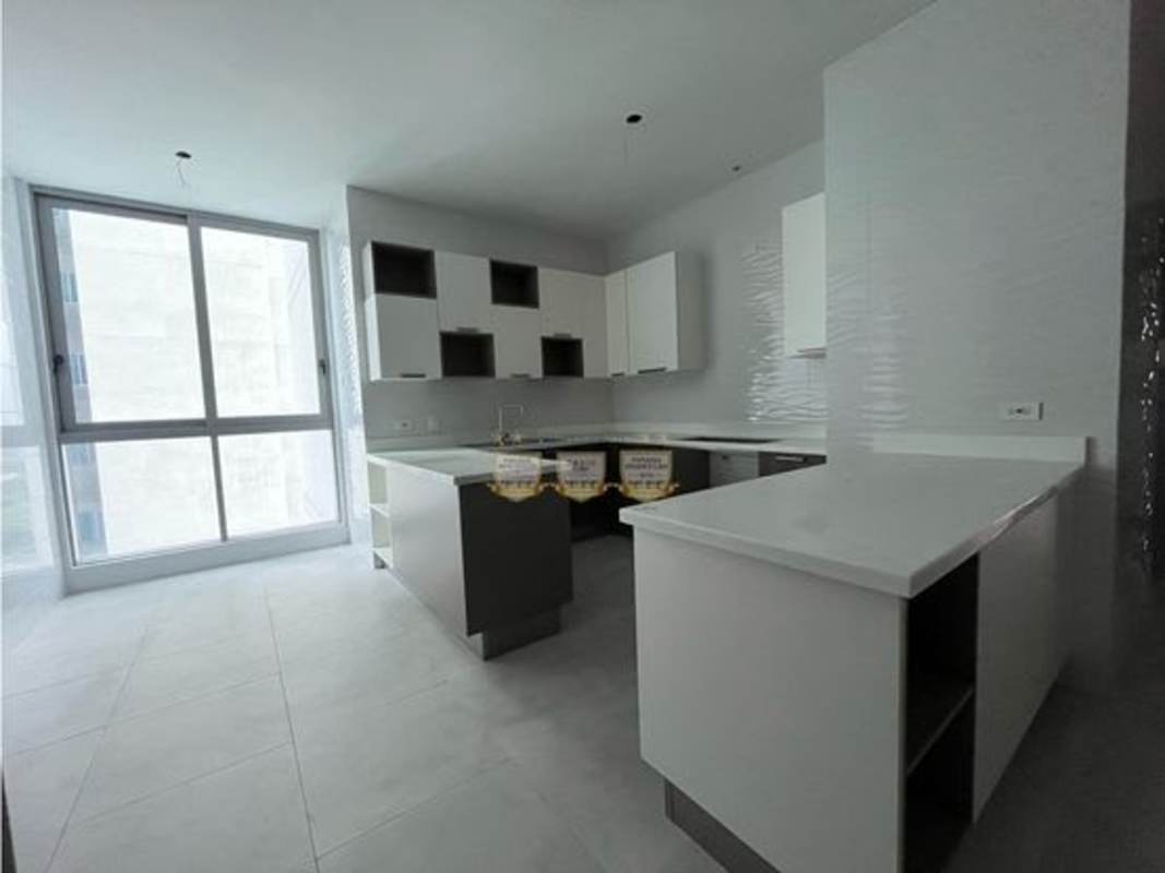 Large modern living room with marble floors and floor-to-ceiling windows overlooking Pacific Ocean at PH Regalia Costa del Este Panama