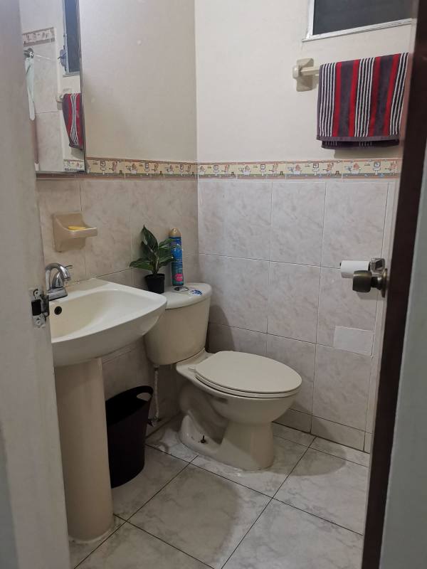 Master bedroom with tile floors and walk-in closet in Residencial Vista Alta Villa Lucre