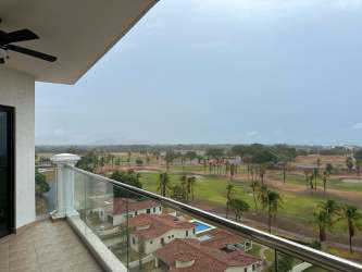 Modern outdoor furniture on balcony with golf course ocean view at Vista Mar Panama