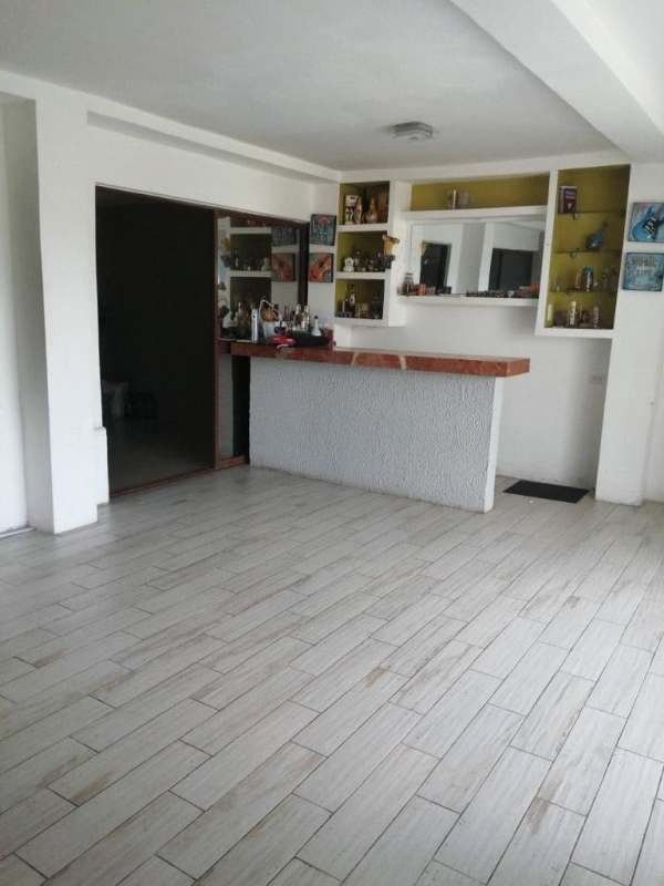 Tiled hallway with black door and wall art of fork and spoon in Residencial San Isidro Panama City