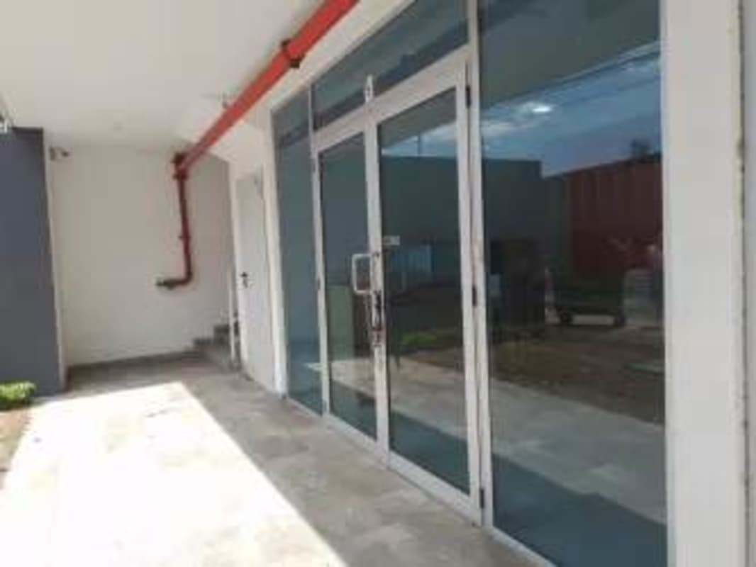Glass entrance of commercial center facing Via España Obarrio Panama