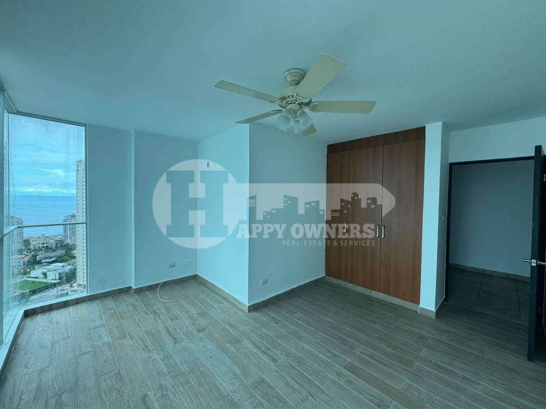 Bedroom with large windows featuring ocean and skyline view in PH Pacific Sea Penthouse Punta Paitilla Panama