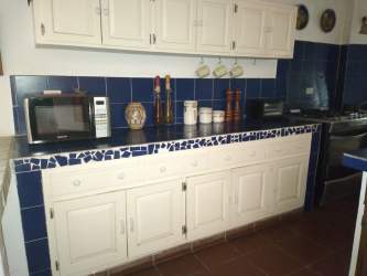 Bedroom with wooden beds, tile floor, attached bath Coronado Panama beach house rental