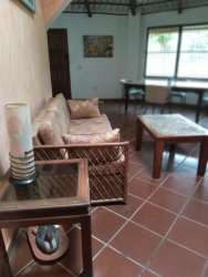 Rustic styled kitchen with blue tiles, white cabinets, appliances in Coronado Beach rental Panama