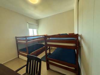 Bright oceanview living room with wicker chairs and TV in PH Cocoli Bijao Panama