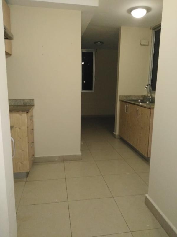 Modern kitchen with granite counters, wooden cabinets and tile flooring in PH Rokas Condado del Rey Panama