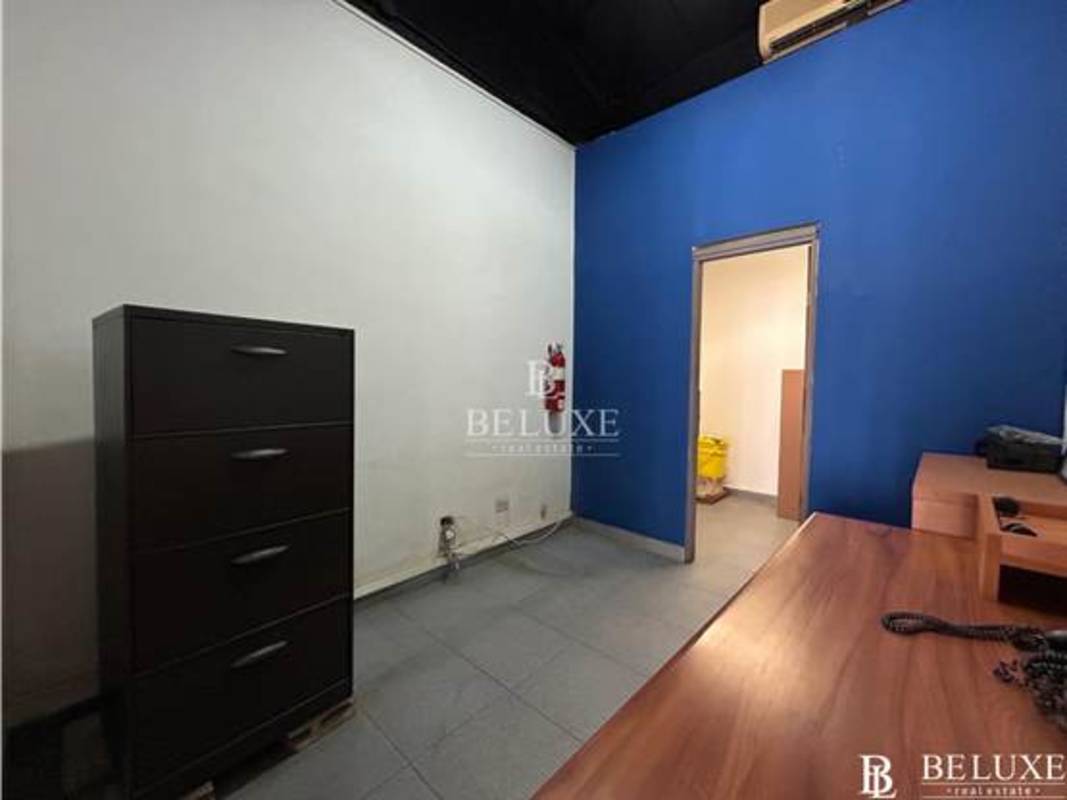 Minimal office with blue wall tile floor inside San Francisco Commercial Plaza Panama