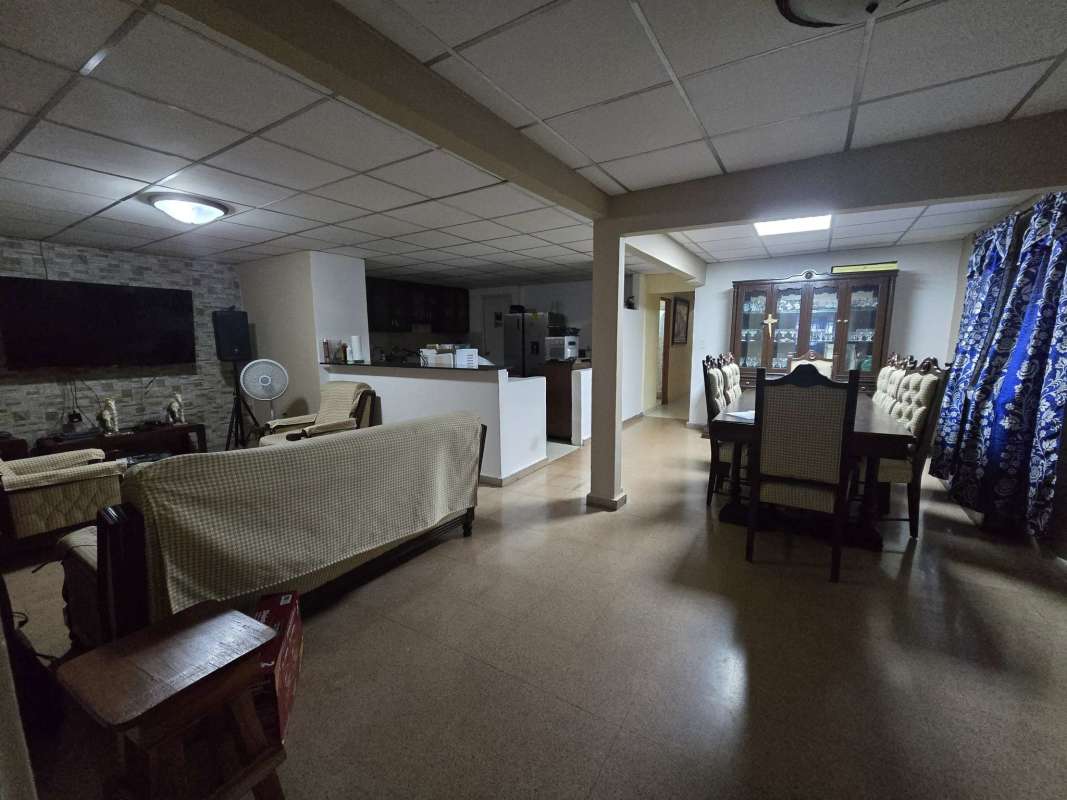 Bedroom twin beds orange curtains horse painting in Cerro Viento house Panama