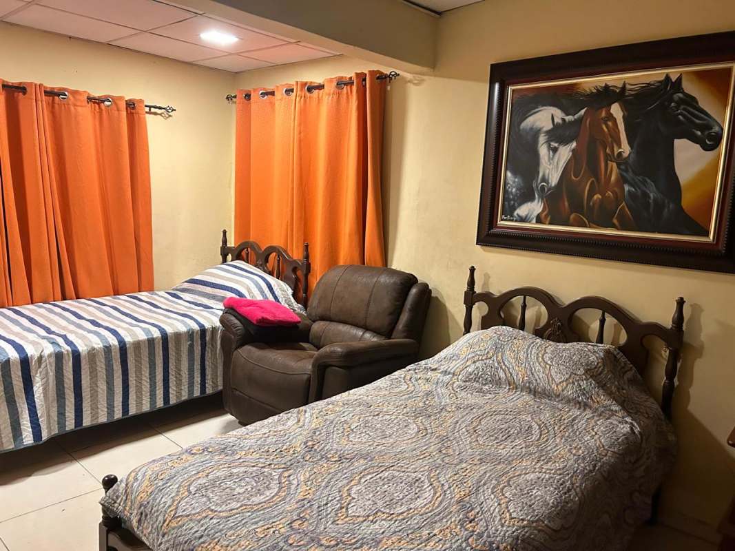 Traditional bedroom with twin beds in Cerro Viento San Antonio 5-bedroom house Panama