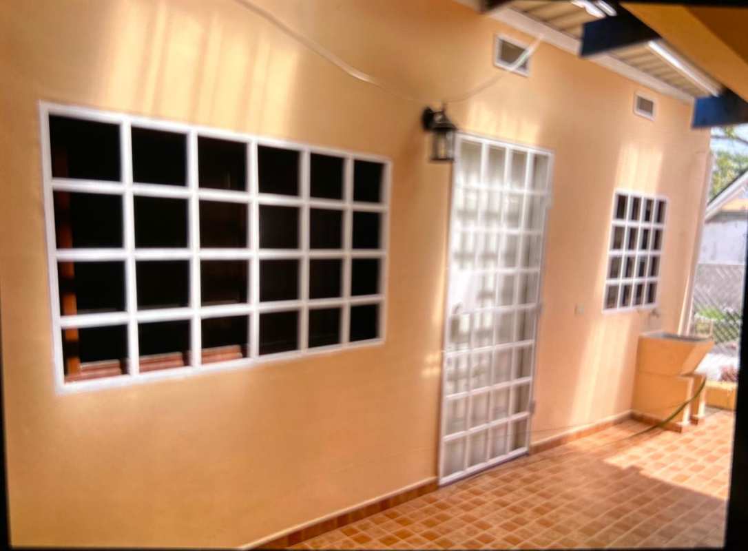 Exterior with metal security door, tiled patio of Cerro Viento San Antonio Panama house for sale