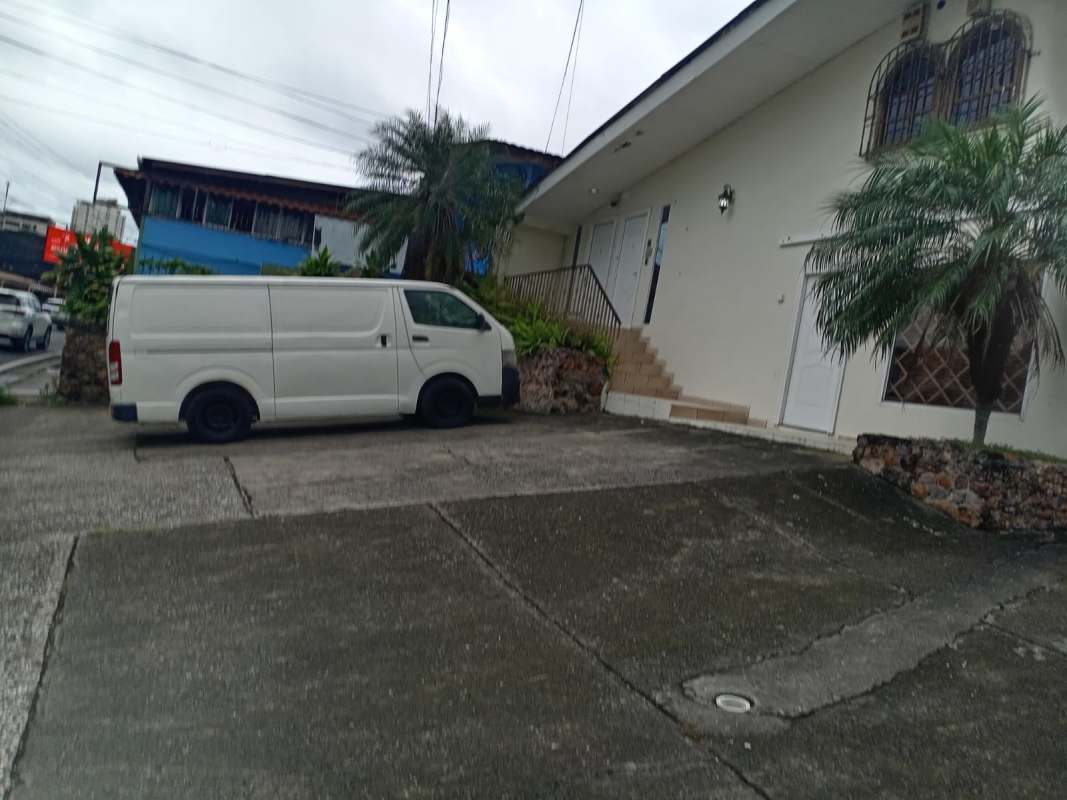 Gated driveway with parked van and landscaped garden of commercial house on Ave La Paz El Ingenio Panama