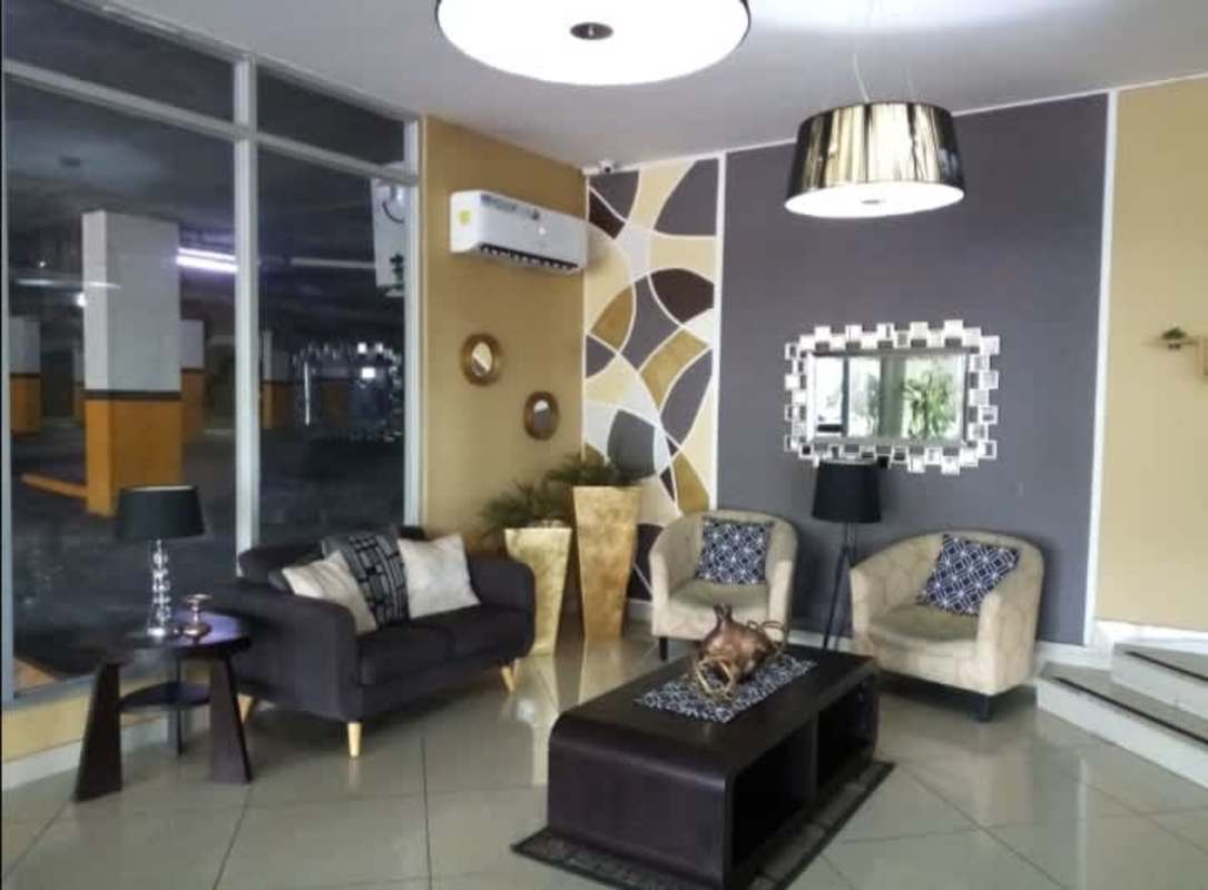 Contemporary lobby with glass walls, stylish furniture, and air conditioning in PH 4 Islas Via Cincuentenario