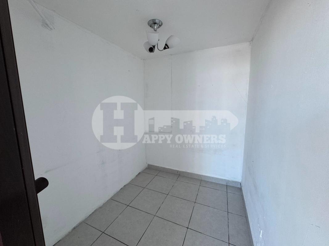 Modern bathroom with beige tiles walk-in shower vanity mirror at PH Premium San Francisco Panama apartment