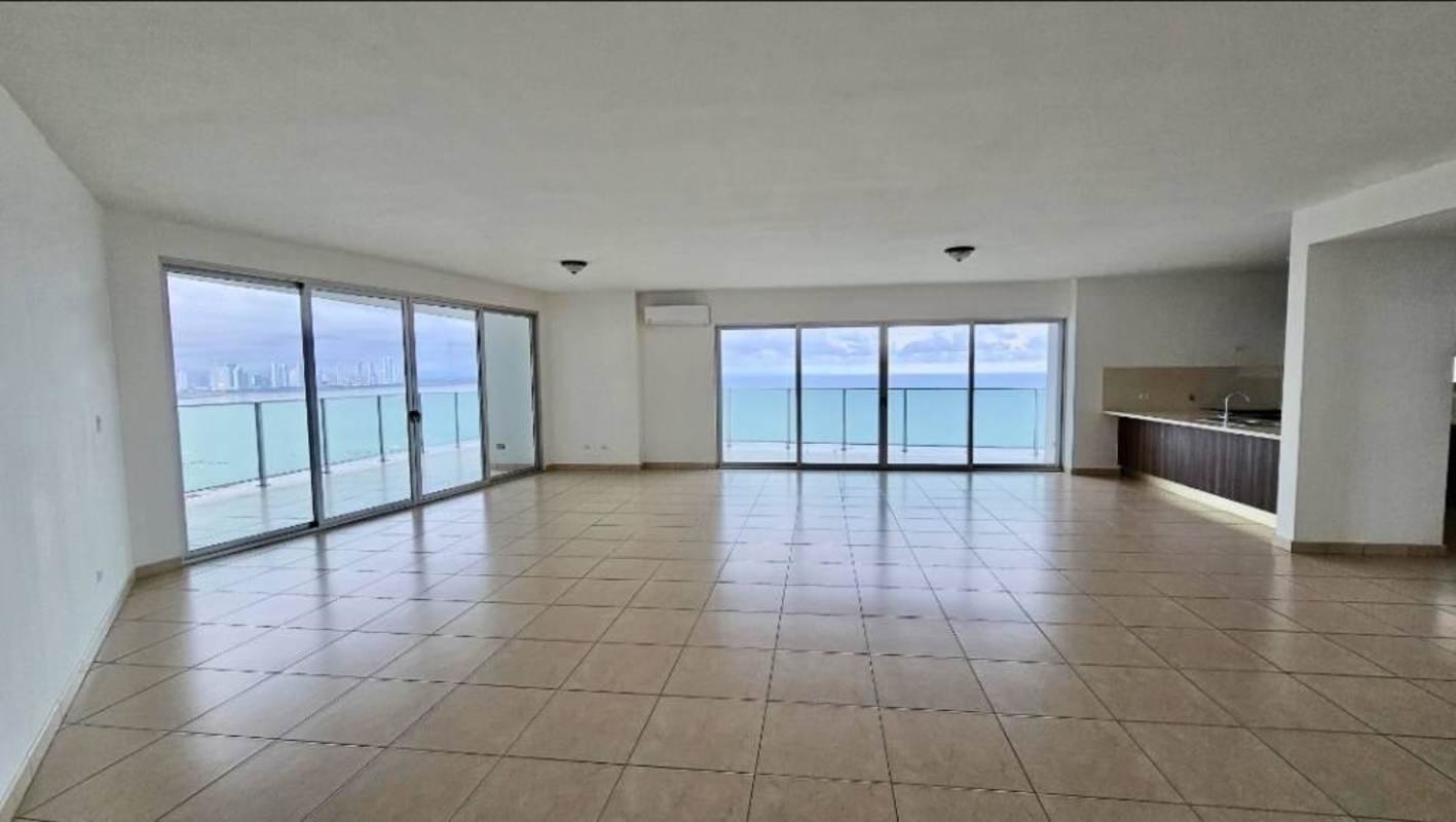 Spacious modern apartment living room with floor-to-ceiling windows and ocean view at PH Oasis on the Bay Panama City